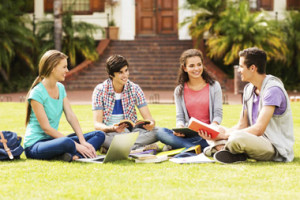 Happy college students studying together on university campus. Horizontal shot.